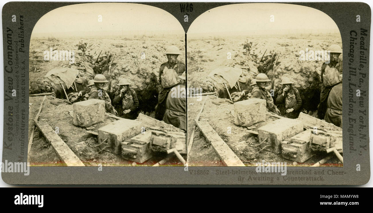 Horizontal, sepia stereocard showing uniformed Scottish soldiers in a trench with boxes of supplies in the foreground. Keystone Stereograph number V18862. The title reads: 'Steel-helmeted Scots Entrenched and Cheerily Awaiting a Counterattack.' Title: 'Scots Entrenched and Cheerily Awaiting a Counter-Attack.'  . between circa 1914 and circa 1918. Keystone View Company Stock Photo