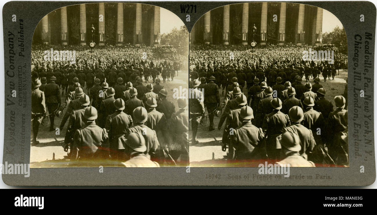 Horizontal, sepia stereocard showing French soldiers parading in Paris. Keystone Stereograph number 18742. The title reads: 'Sons of France on Parade in Paris.' Title: 'Sons of France on Parade in Paris.'  . 1918. Keystone View Company Stock Photo