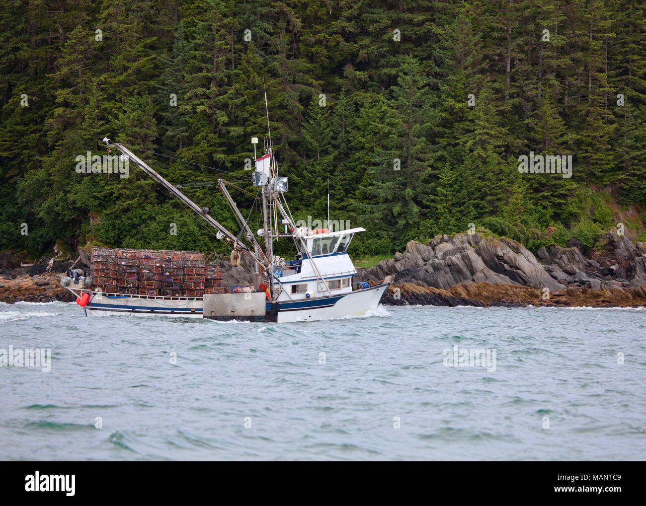 Crab fishing boat near the shore of the Lynn Canal in Southeast Alaska loaded with empty crab