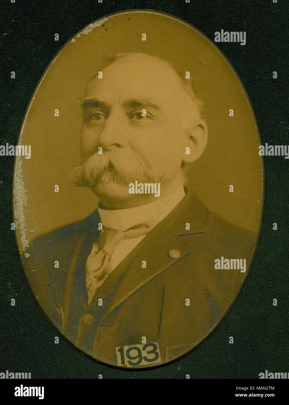 Formal bust portrait of S. E. Hadlock wearing a suit and tie, and