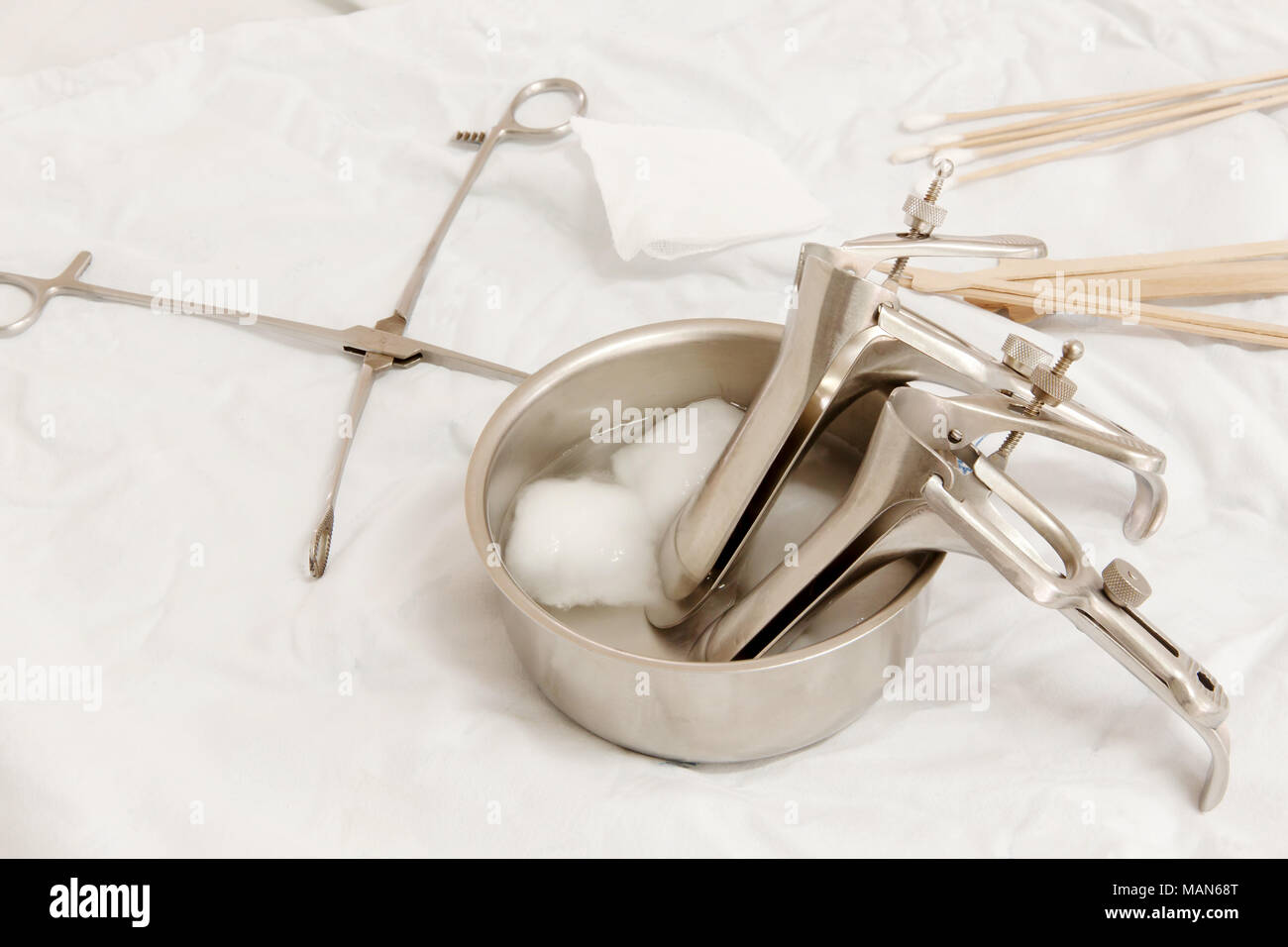 Vaginal Speculum sterilized in alcohol on Medical instruments table