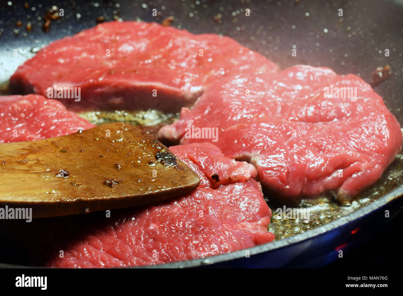Raw sirloin beef steaks on frying pan. Stock Photo