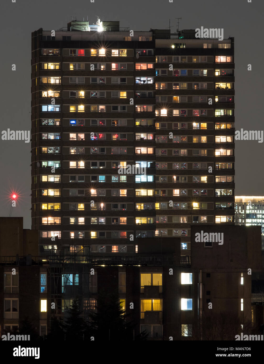 Towerblock at night, showing the variety of lives and lights that exist in a single apartment block in London Stock Photo