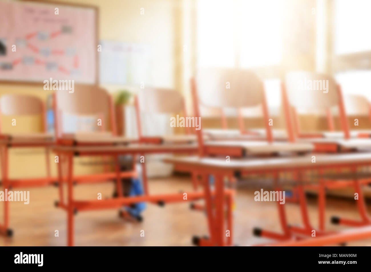 Blurred image of empty classroom with school desks, chairs and blackboard. Education concept. Stock Photo