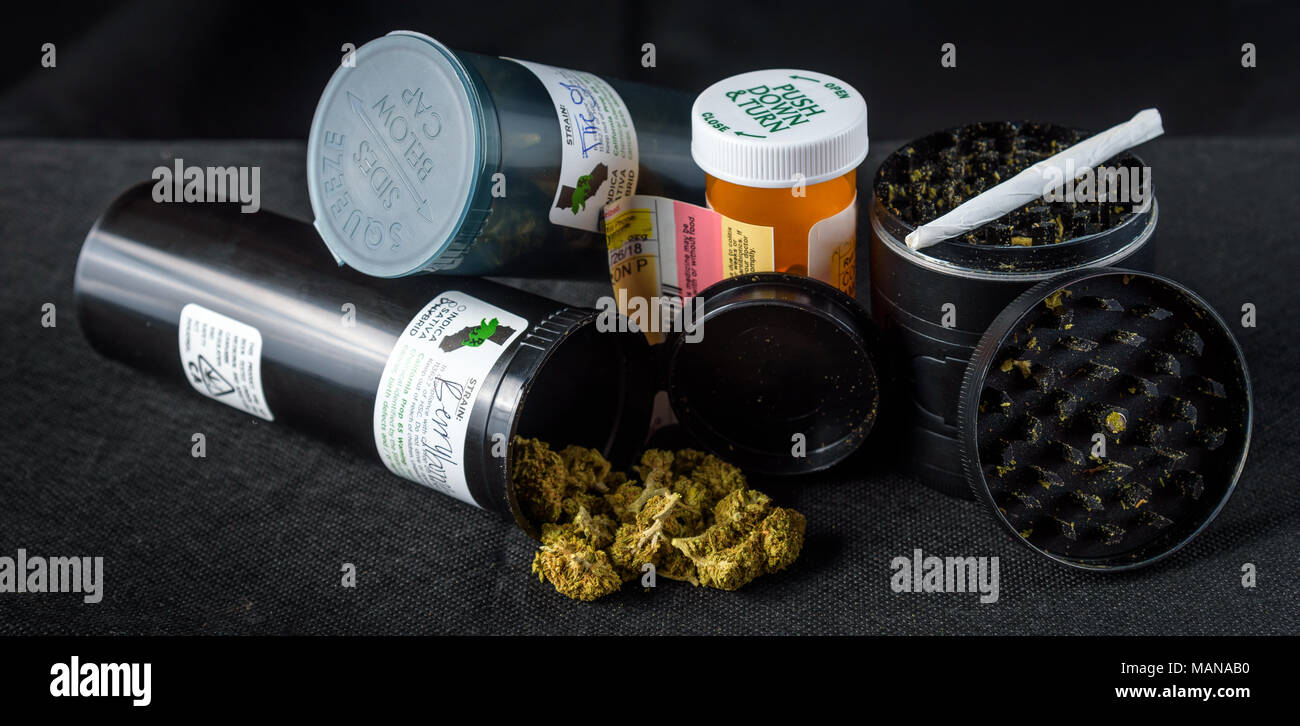 prescription bottles of medical marijuana tipped over with buds spilling out. Black background Stock Photo