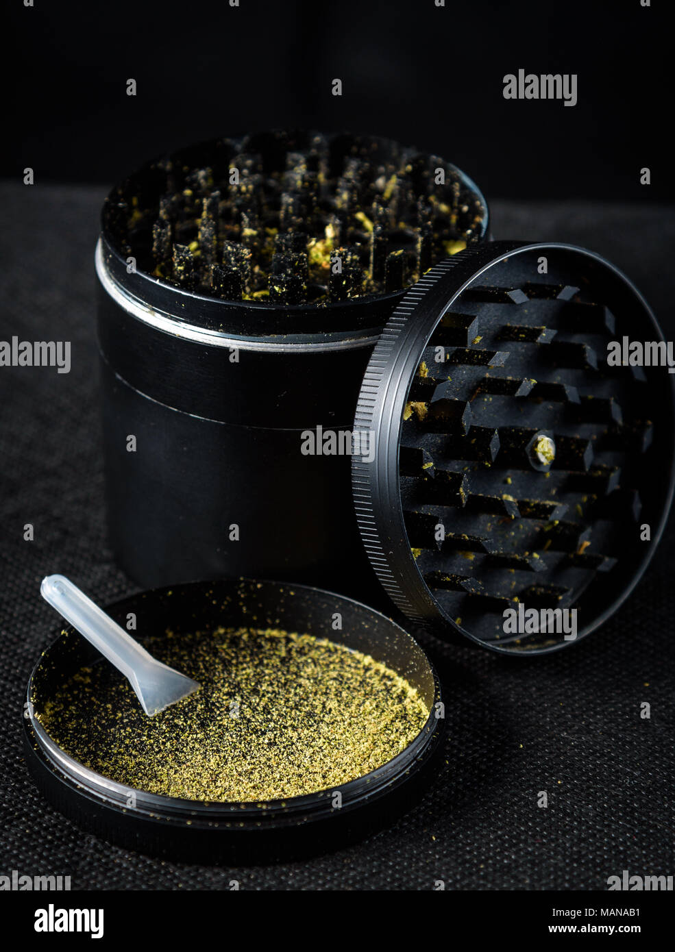 A medicinal marijuana grinder with keef and scraper. Black background Stock  Photo - Alamy