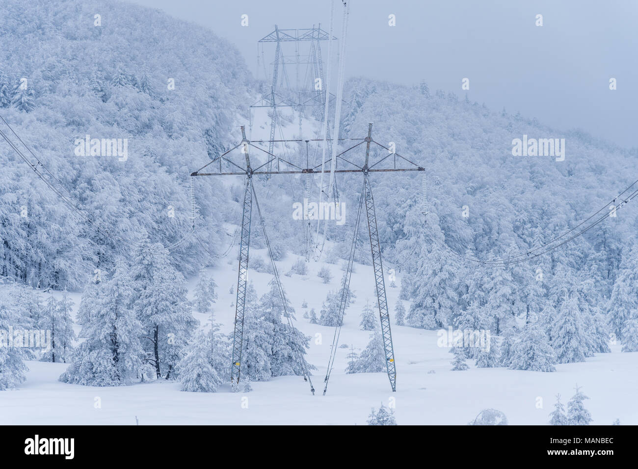 Electricity pylons in winter mountains in Bulgaria Stock Photo - Alamy