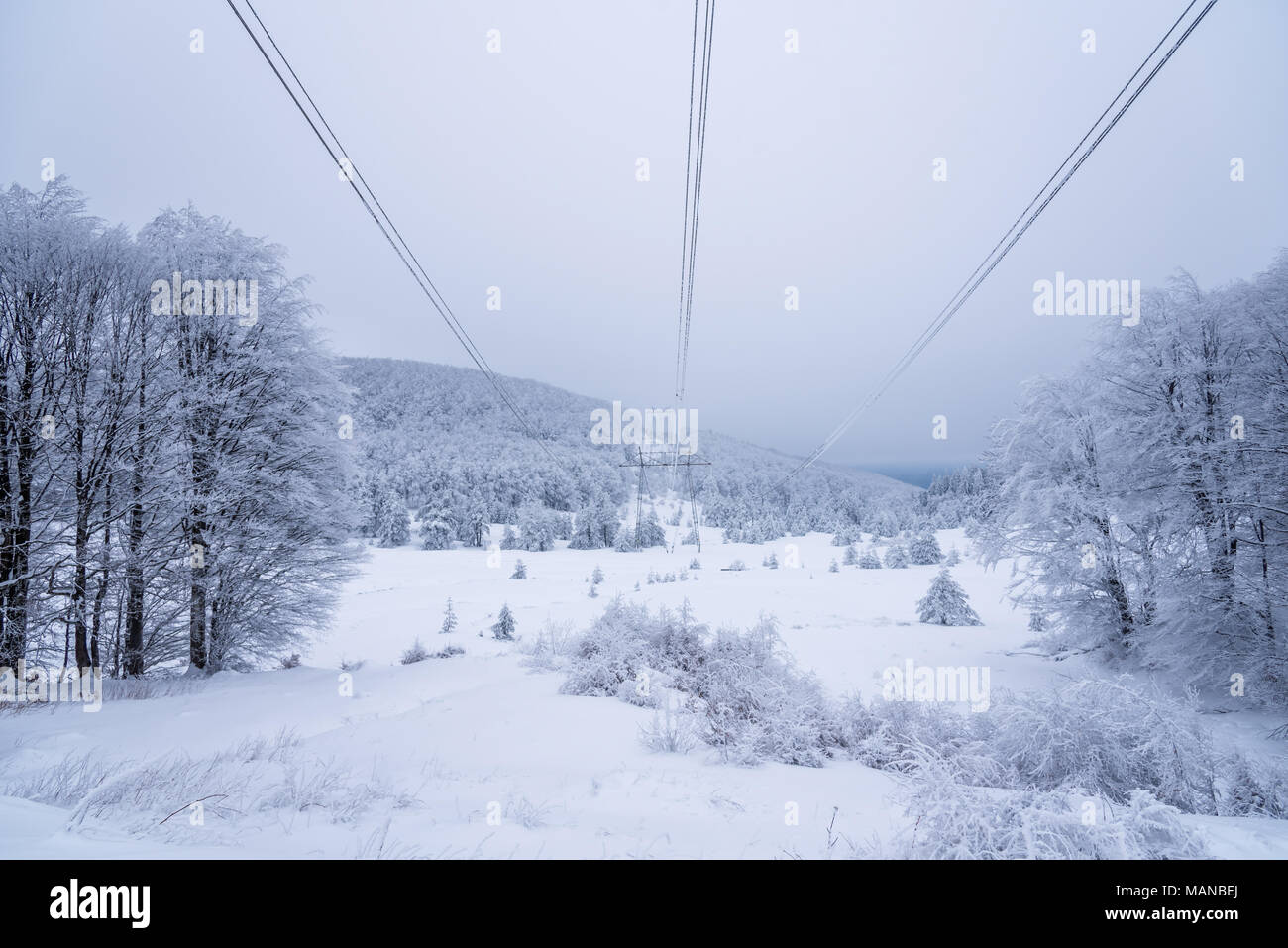 Electricity pylons in winter mountains in Bulgaria Stock Photo - Alamy
