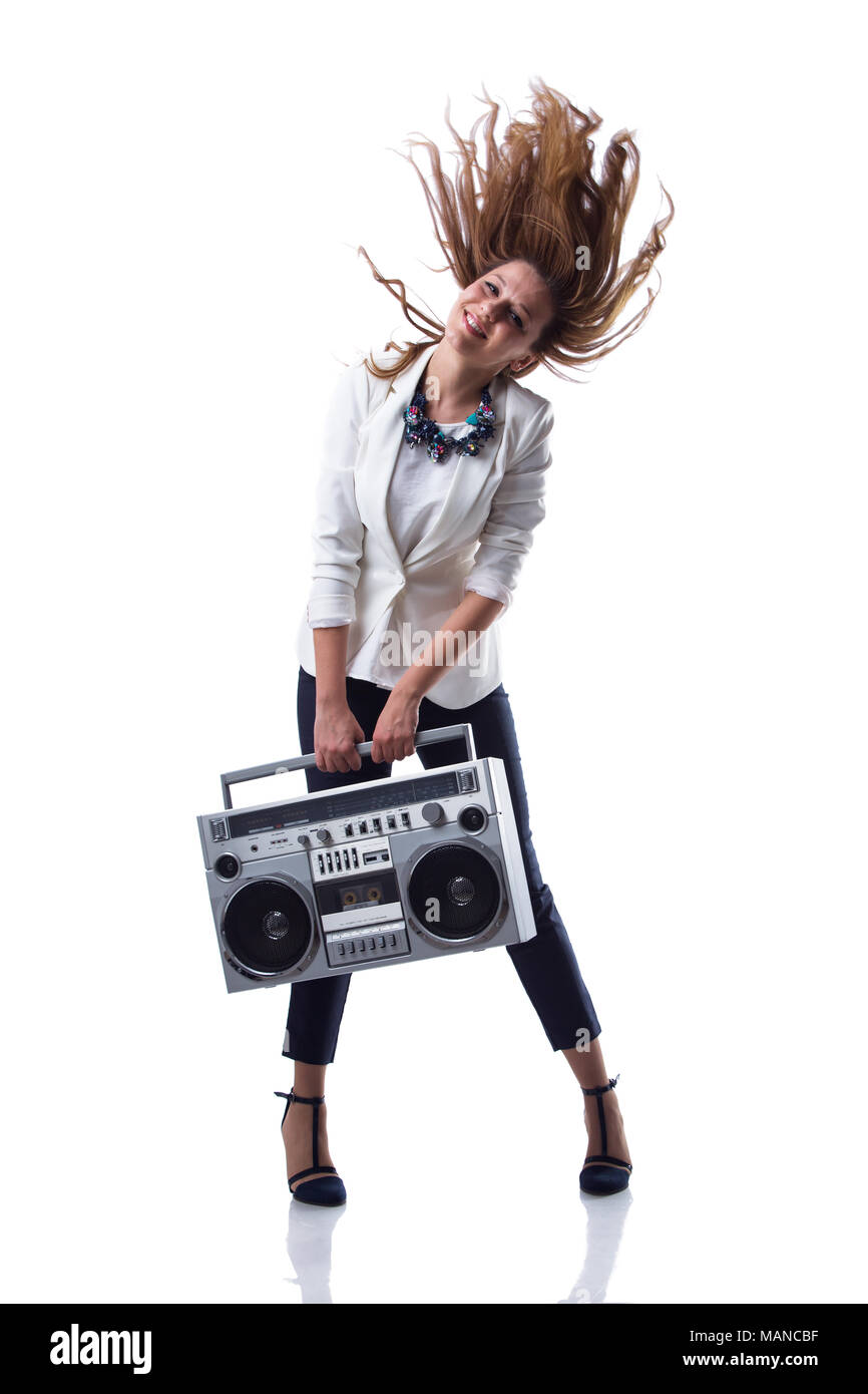 Smiling business girl holding retro boom box on white background Stock Photo