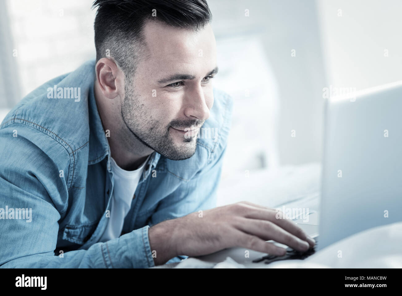 Joyful bearded man pressing the button Stock Photo