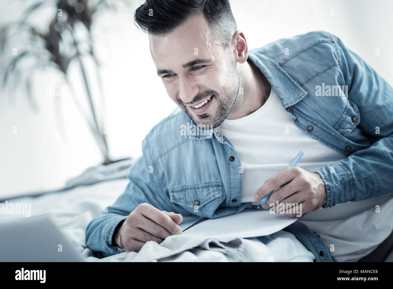 Happy nice man writing a plan Stock Photo