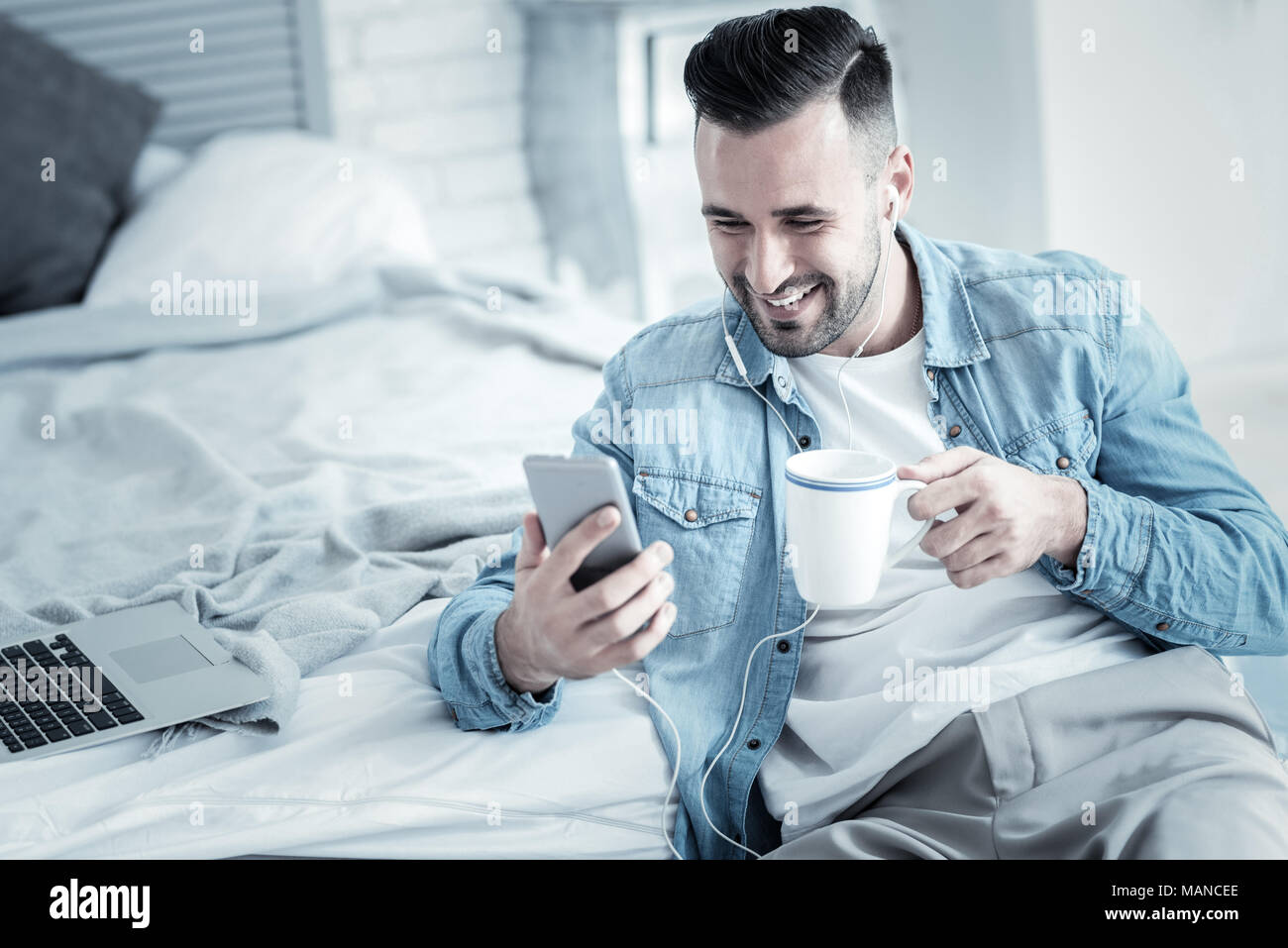 Positive joyful man having tea Stock Photo