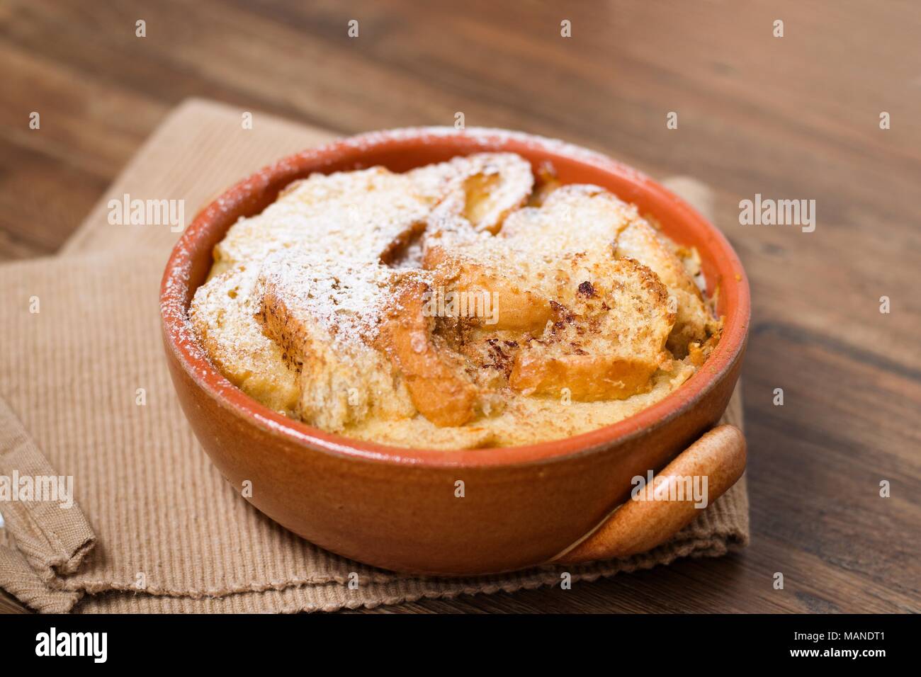 Bread and butter pudding with powdered sugar Stock Photo Alamy