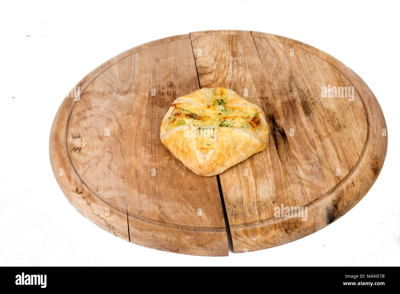 cheese dumplings and ham on a wooden plate in display on white background Stock Photo