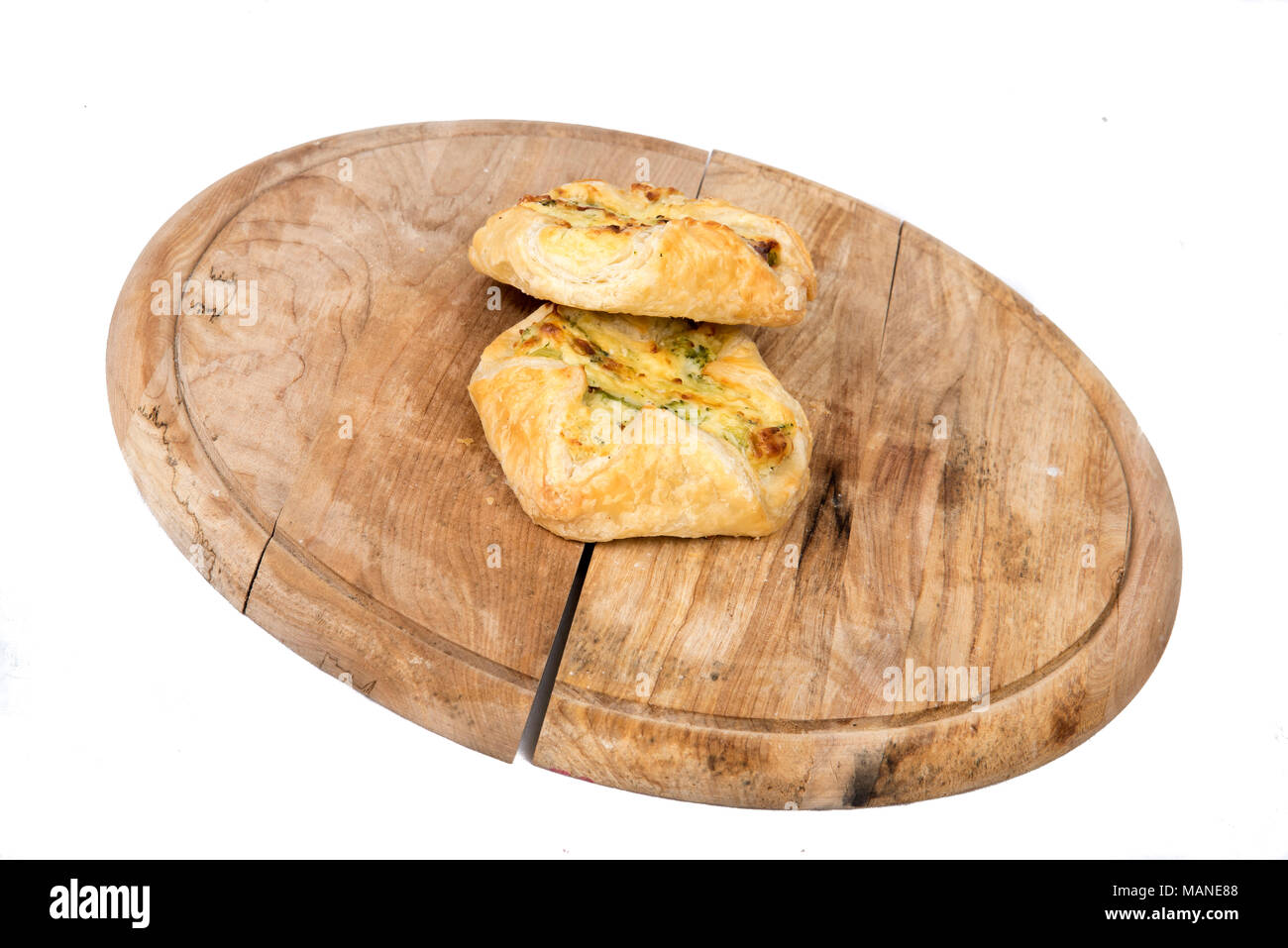 cheese dumplings and ham on a wooden plate in display on white background Stock Photo
