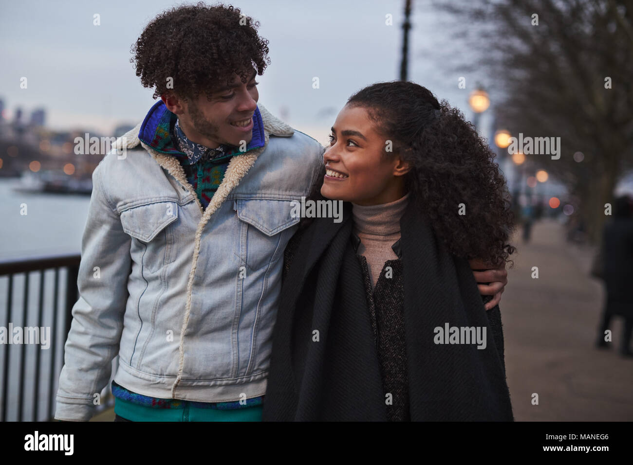 Couple Walking Along South Bank On Winter Visit To London Stock Photo