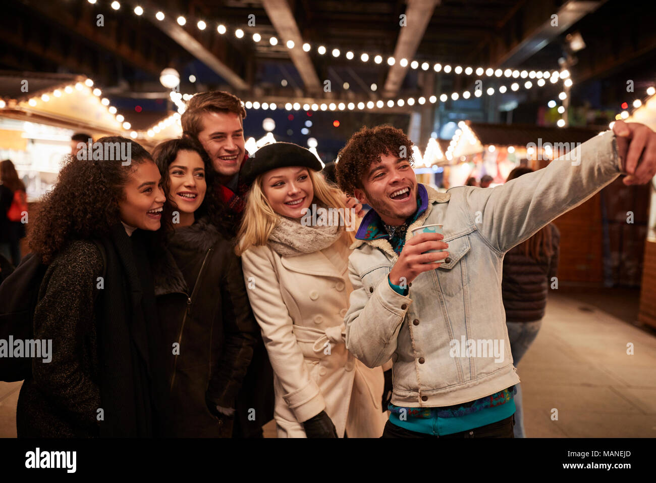 Young Friends Posing For Selfie At Christmas Market Stock Photo