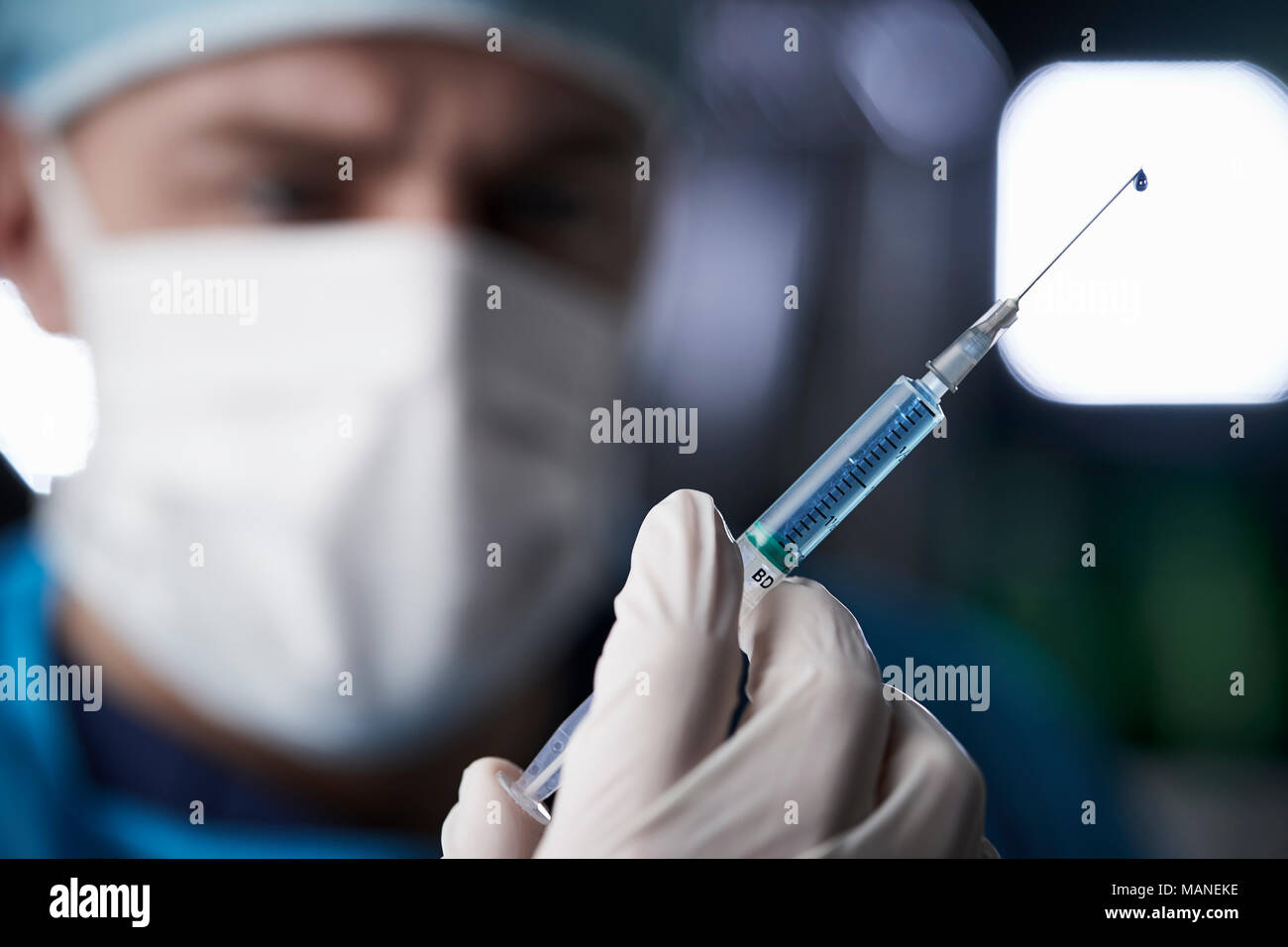 Male healthcare worker preparing syringe, close up Stock Photo