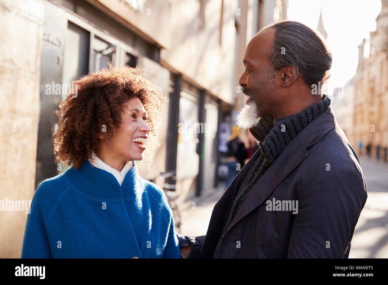 Middle Aged Couple Walking Through City In Fall Together Stock Photo