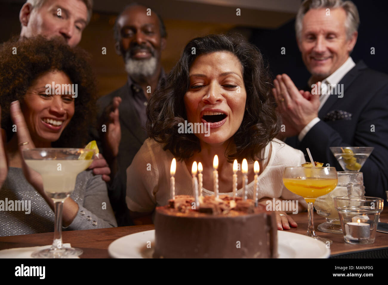 Group Of Middle Aged Friends Celebrating Birthday In Bar Stock Photo
