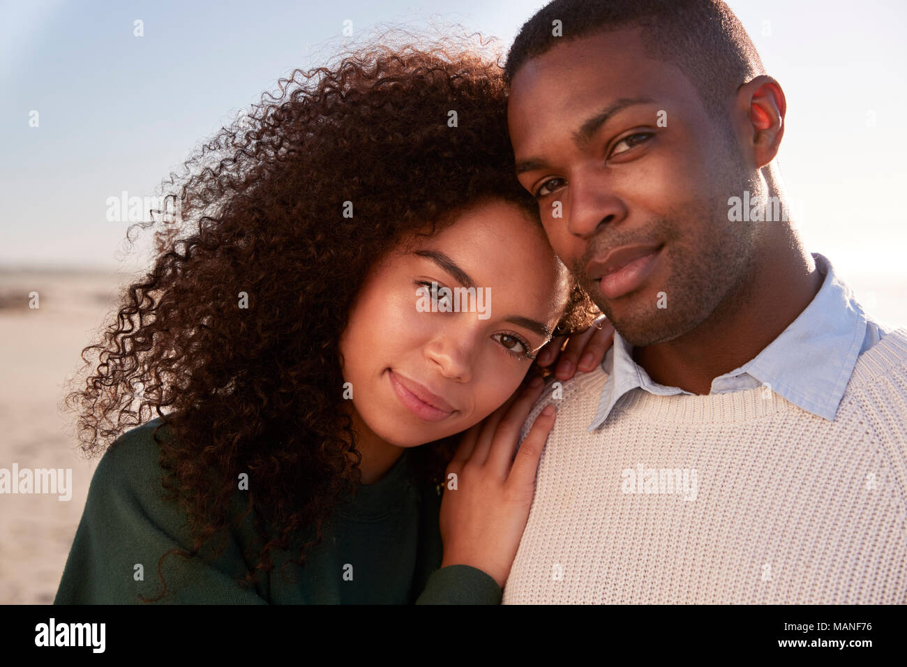 Portrait Of Couple On Walking Along Winter Beach Together Stock Photo