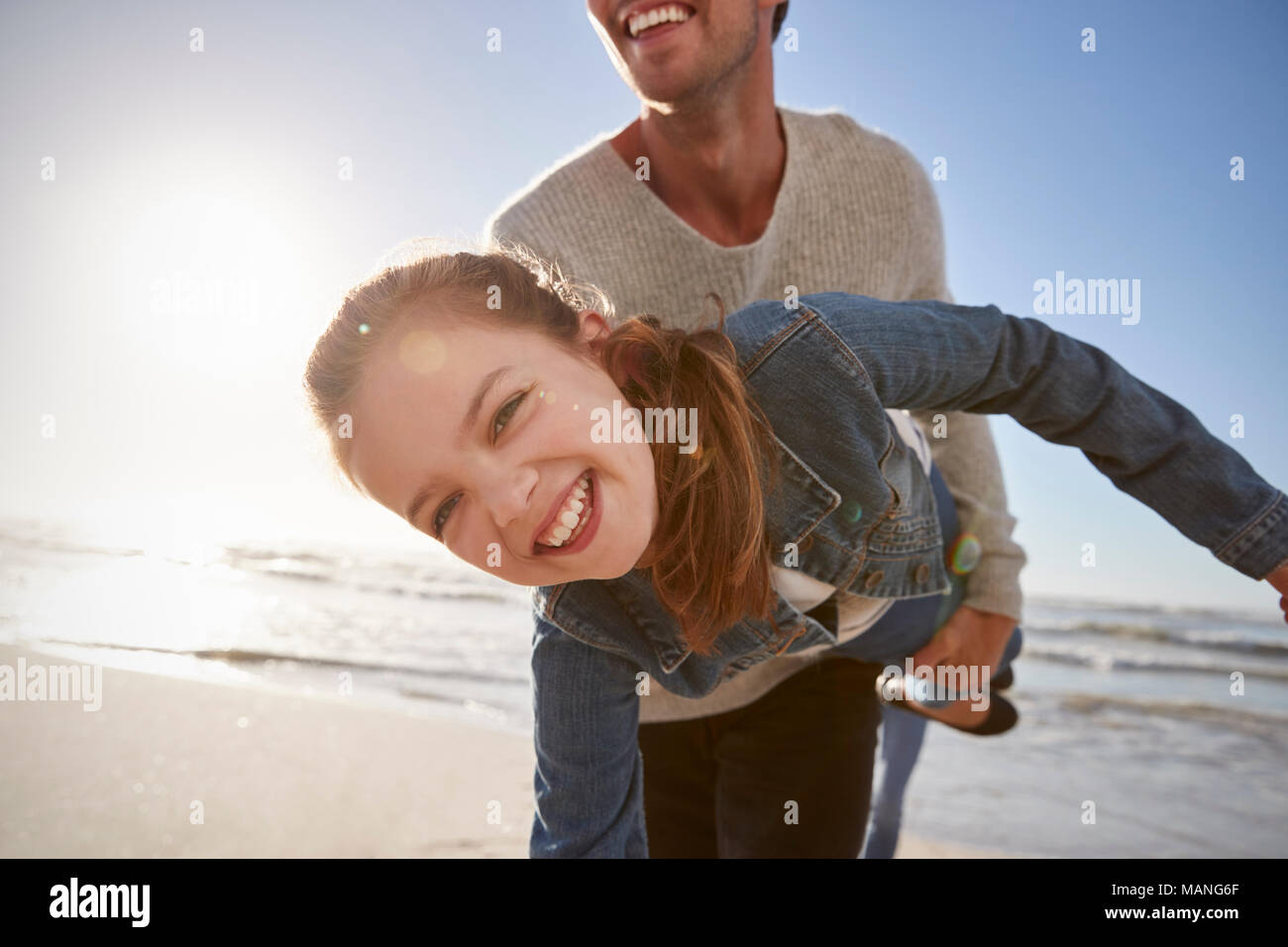 Father With Daughter Having Fun On Winter Beach Together Stock Photo