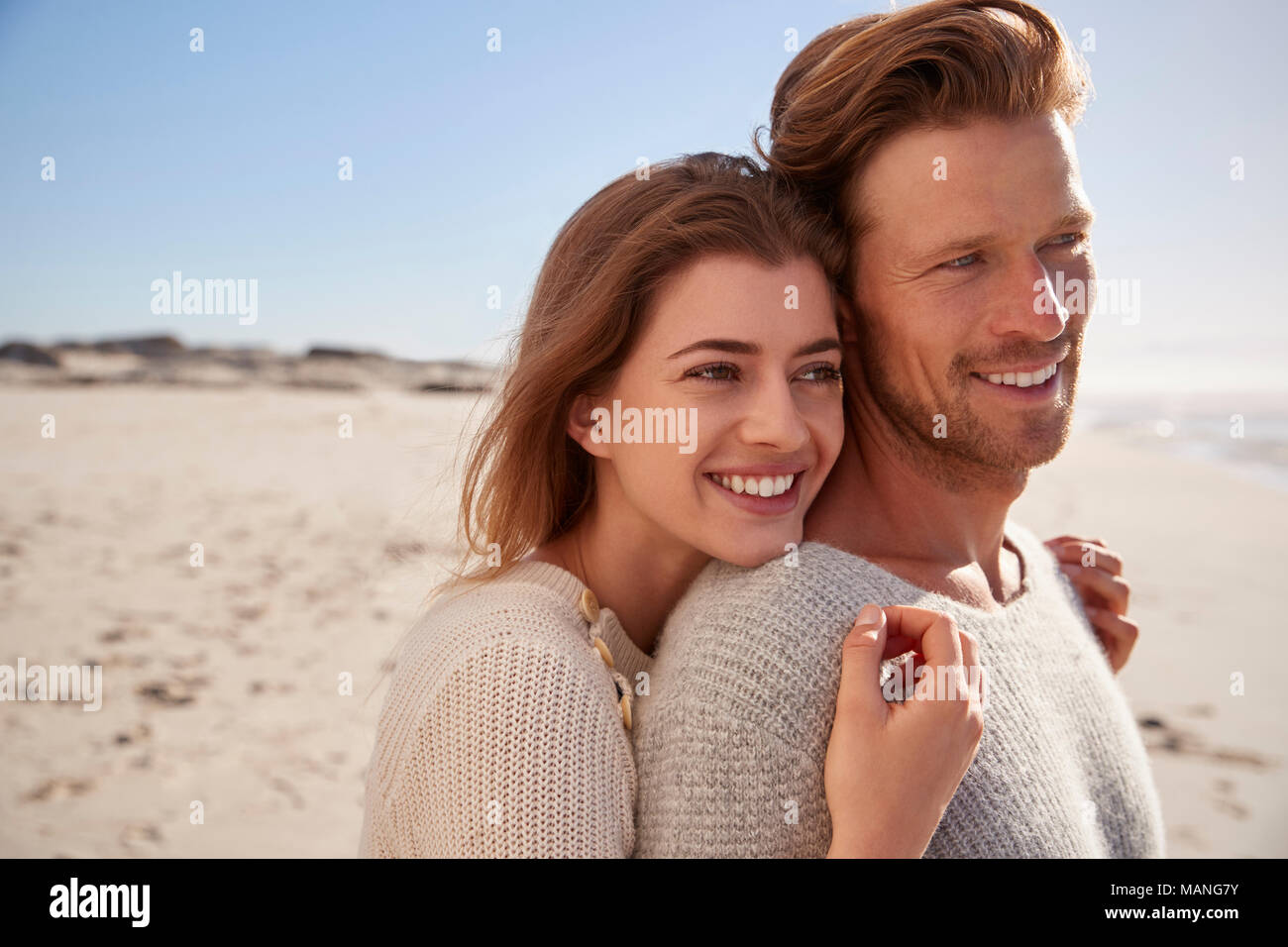 Romantic Couple Embracing On Winter Beach Stock Photo