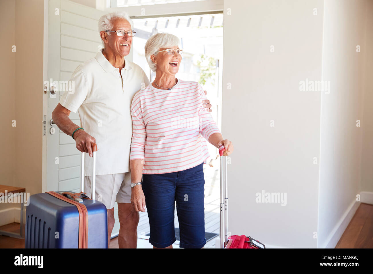 Senior Couple Arriving At Summer Vacation Rental Stock Photo