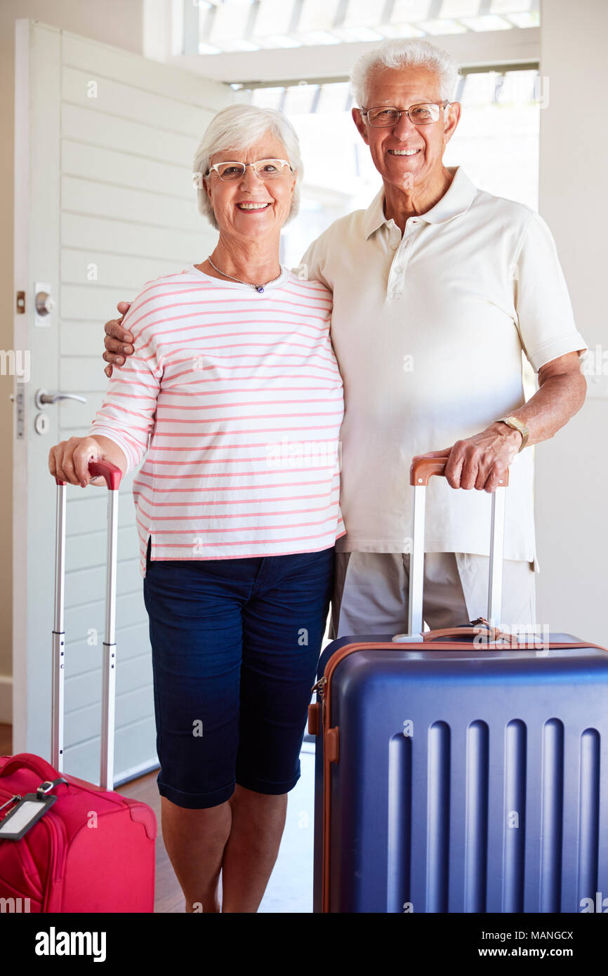 Portrait Of Senior Couple Arriving At Summer Vacation Rental Stock Photo