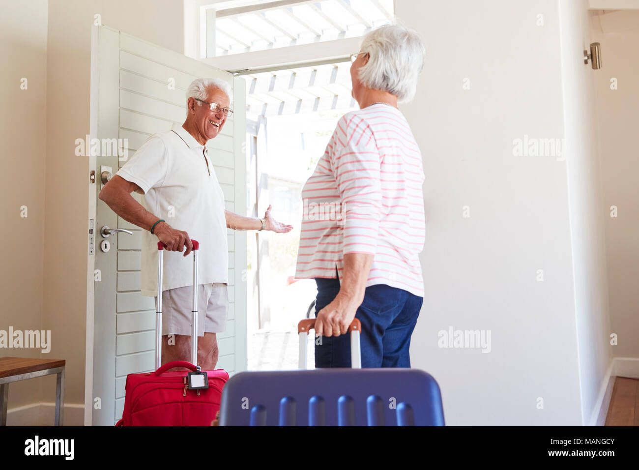 Senior Couple Leaving Summer Vacation Rental Stock Photo