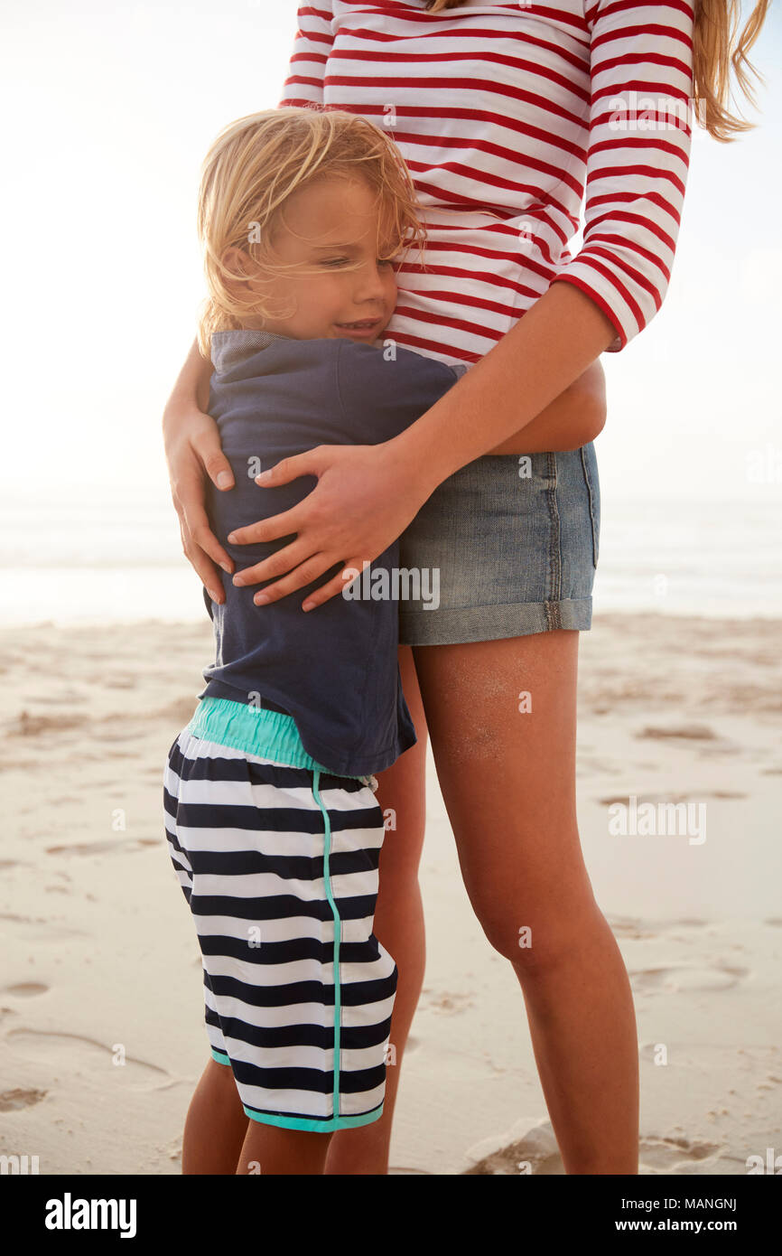 Close Up Of Mother Hugging Son On Summer Beach Vacation Stock Photo