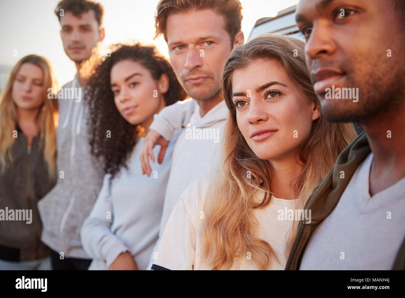 Young adult friends on a road trip standing by car, close up Stock Photo