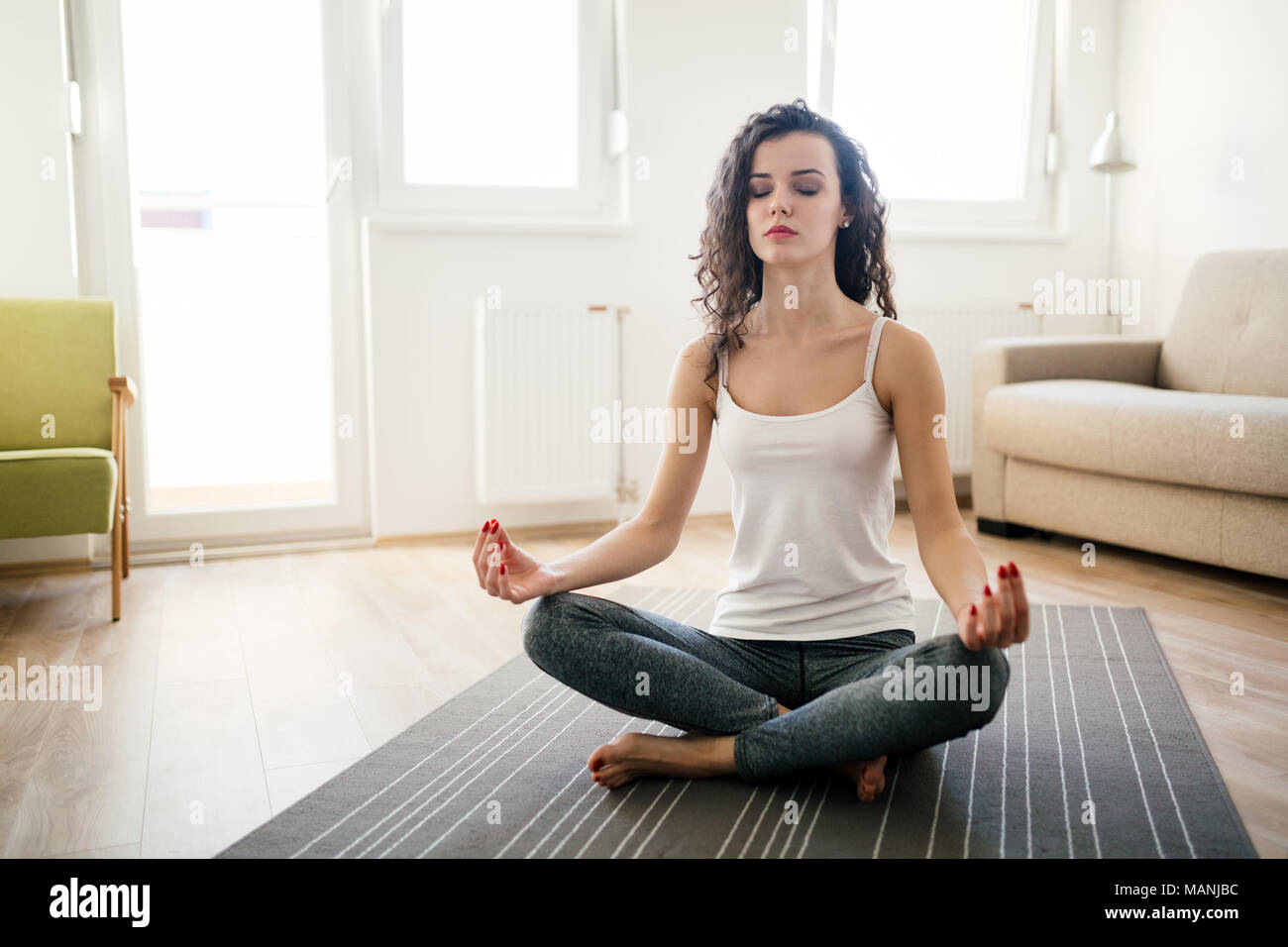 Young attractive woman relaxing and practicing yoga Stock Photo