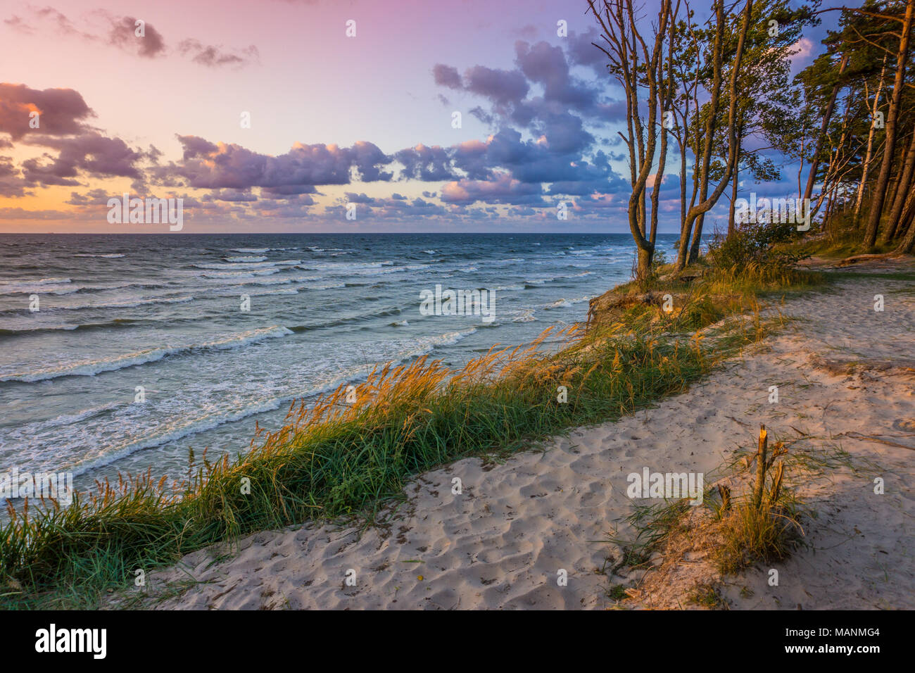 Beautiful sunset on Baltic Sea with colorful cloudy sky, golden sand ...