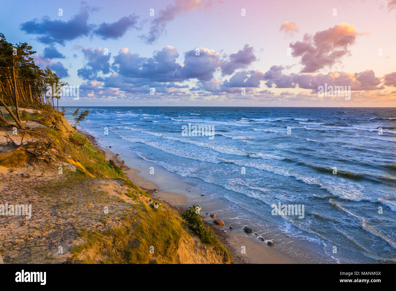 Beautiful sunset on Baltic Sea with colorful cloudy sky, golden sand ...