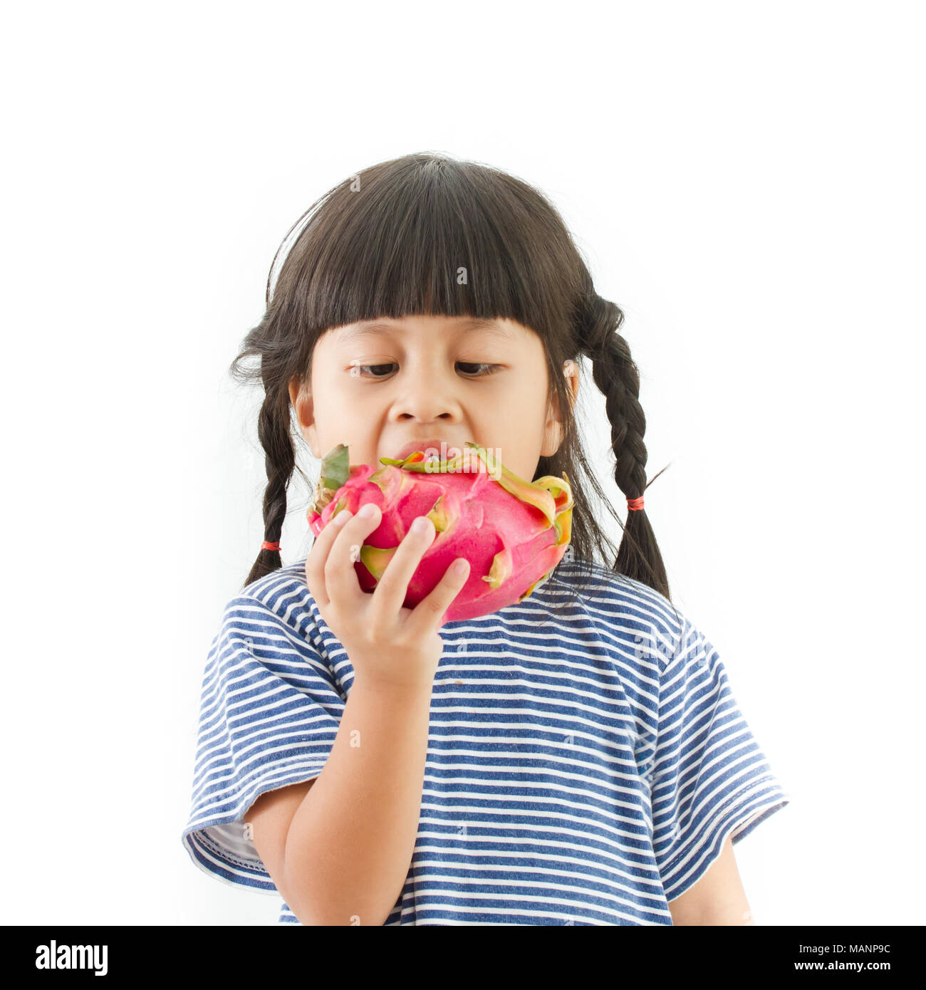 Dragon fruit in hand girl on white background, asian girl  wear pattern cloth, Stock Photo