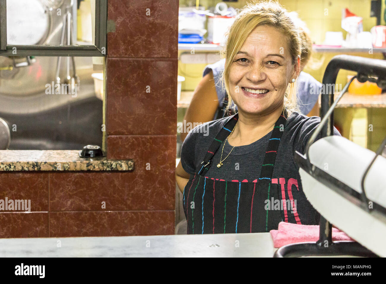 Buenos Aires, Argentina - March 20th, 2018: A female cook at the counter of the restaurant  - bodegon El Trebol in Villa Luro, Buenos Aires, Argentina Stock Photo