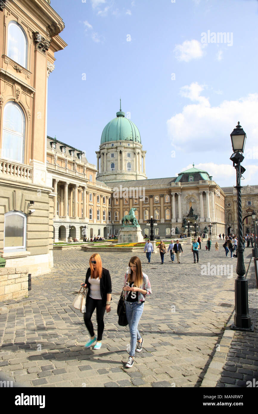 Two women ladies girls walking through the grounds of the royal palace