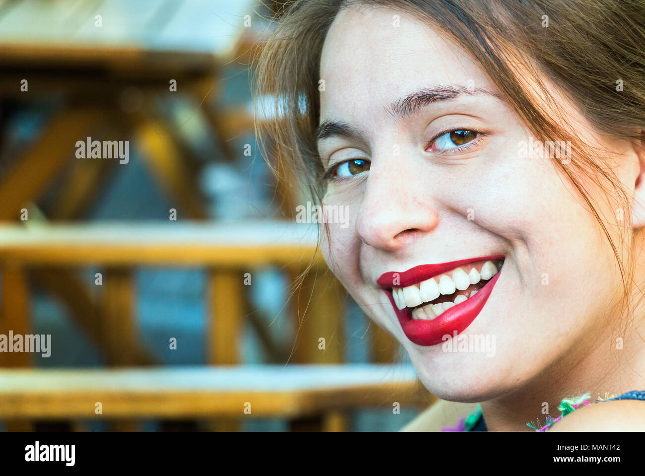 Portrait of a young woman blonde, looking at camera, laughing, cheerful, toothy smile. Stock Photo