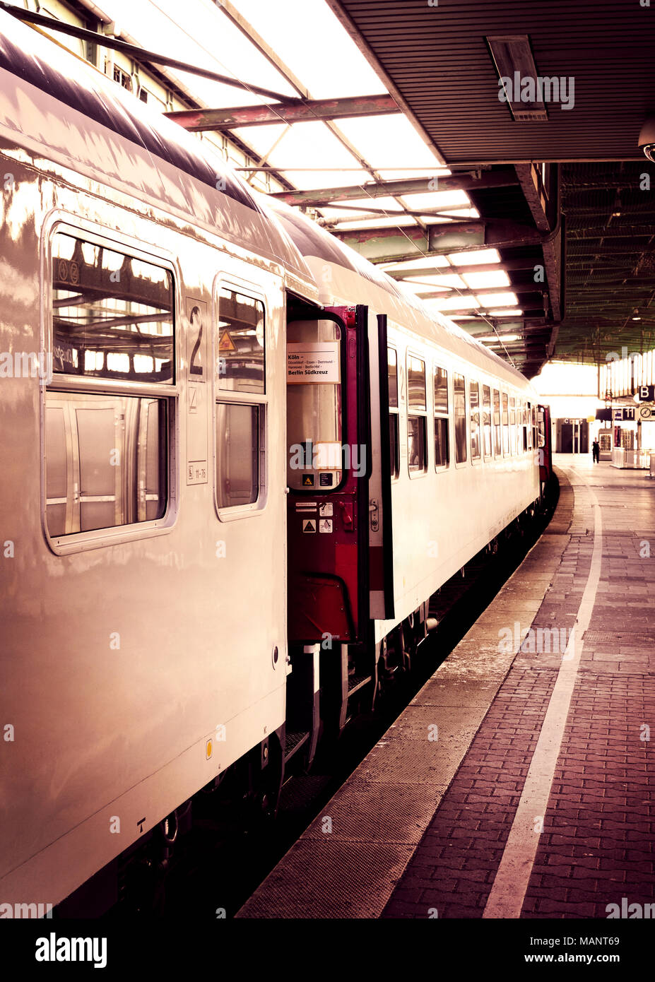 Old train in a railway station with open doors. Sepia toned image. Stock Photo