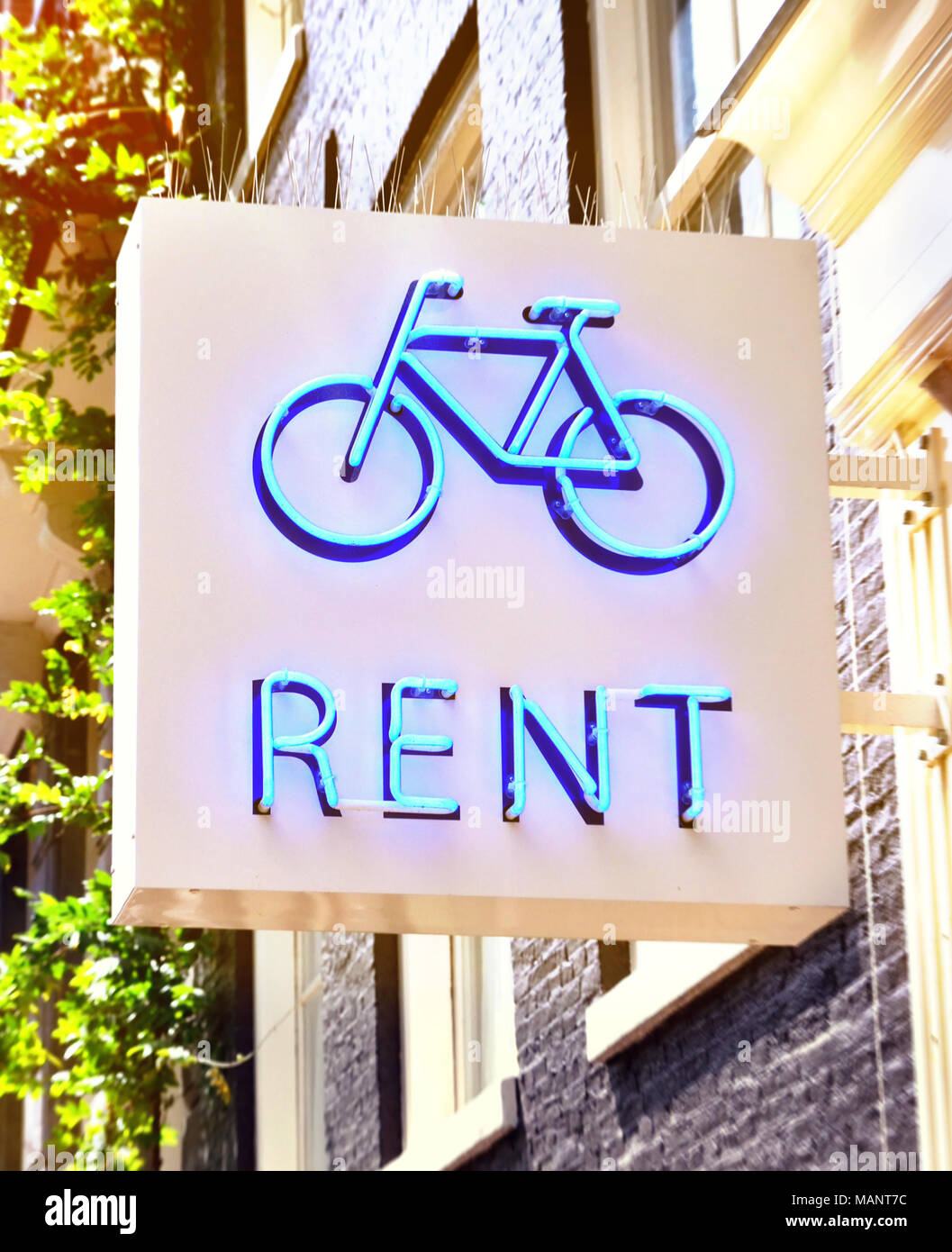 Bicycle rent or bike rental store sign. Bike symbol at a house facade, rent a bike. Stock Photo