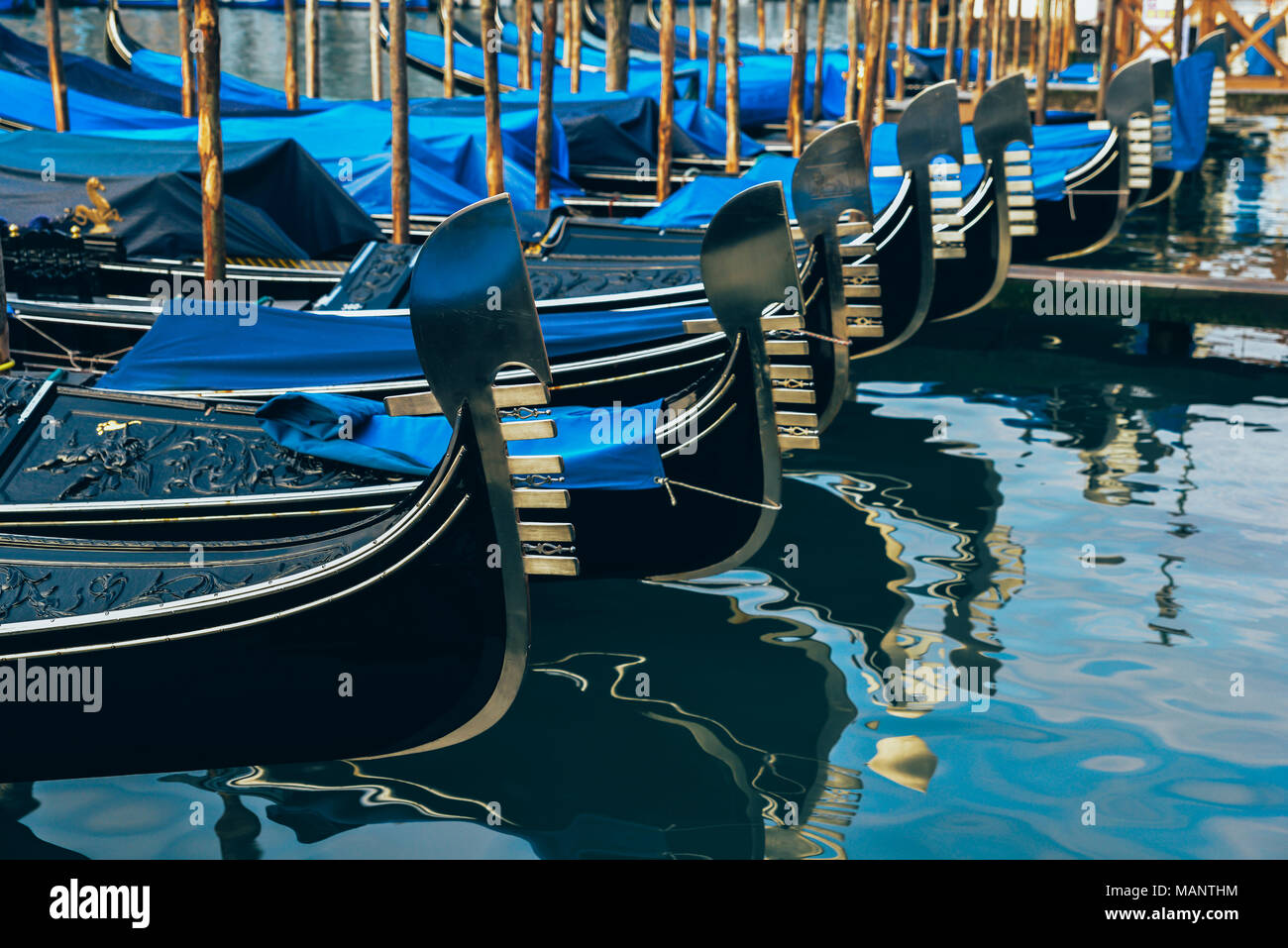 Rows of gondolas on a canal in Venice, Italy Stock Photo
