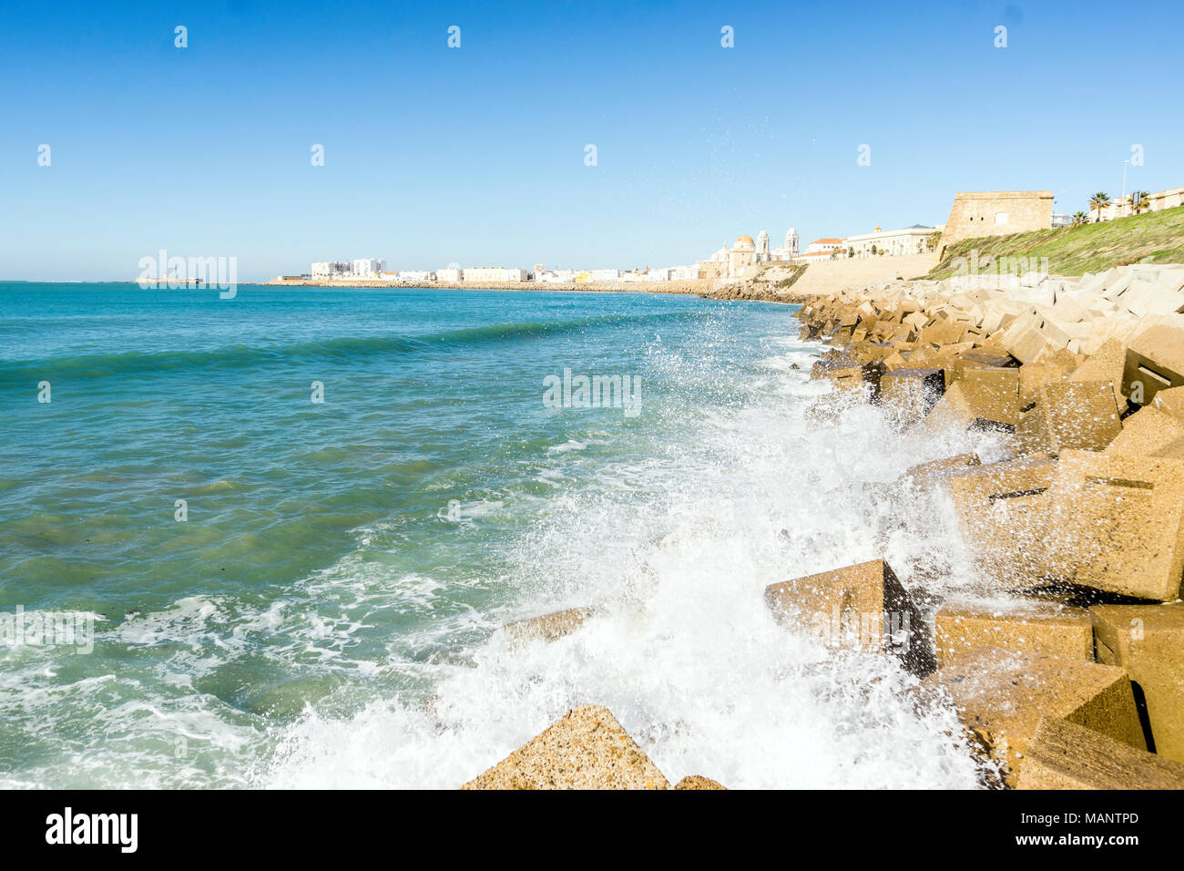 Atlantic waves breaking on the urbanized shore of old Cadiz, Andalusia, Spain Stock Photo