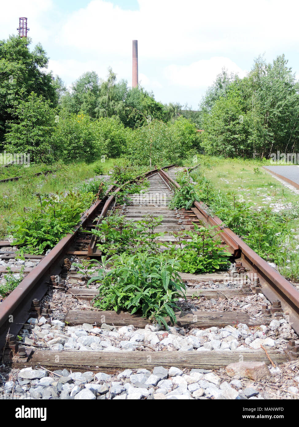 Abandoned and overgrown railway track, outdoor scene. Stock Photo