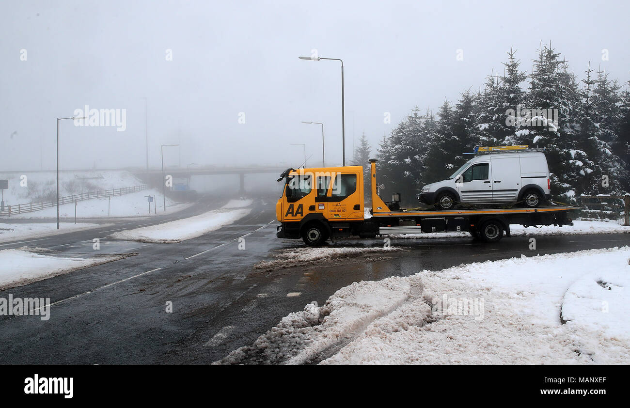 An AA van rescues a car in Saddleworth in the Greater Manchester, as five weather warnings are in place as heavy rain and snow blight swathes of the country on Easter Monday. Stock Photo