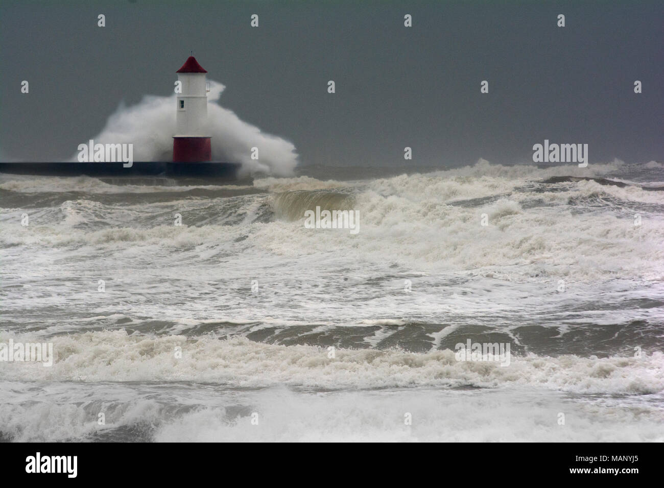 Lighthouse in Berwick-upon-Tweed in heavy storm with high waves Stock Photo