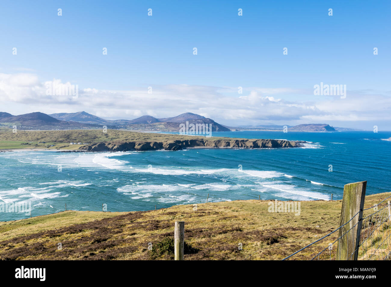 A view of the Irish coastline near Malin in county Donegal Ireland.  just beyond the ocean waves you can see sea cliffs and the mountains Stock Photo