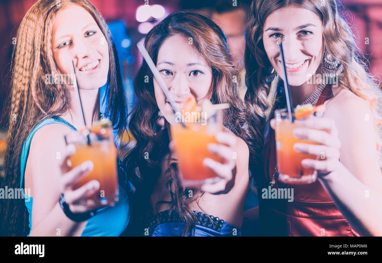 Group of party people women with cocktails in a bar or club Stock
