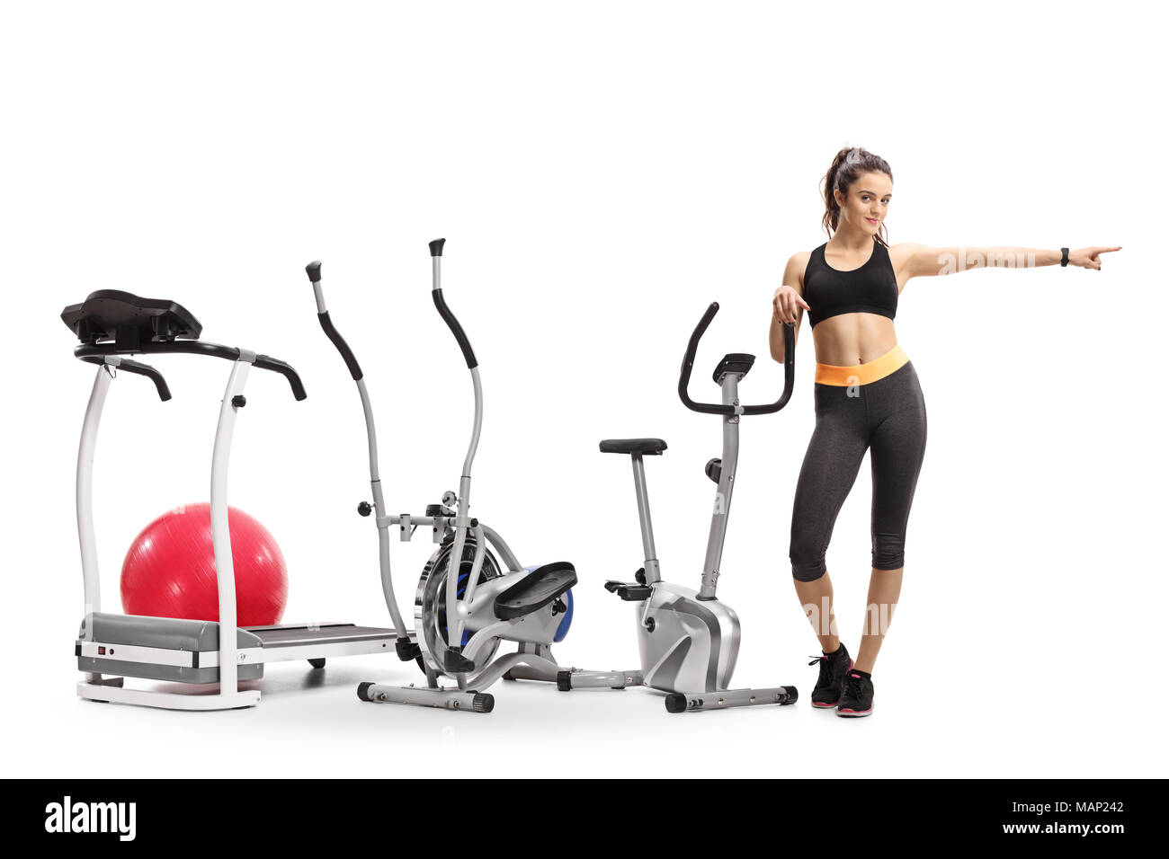 full-length-portrait-of-a-fitness-woman-with-exercise-machines-pointing