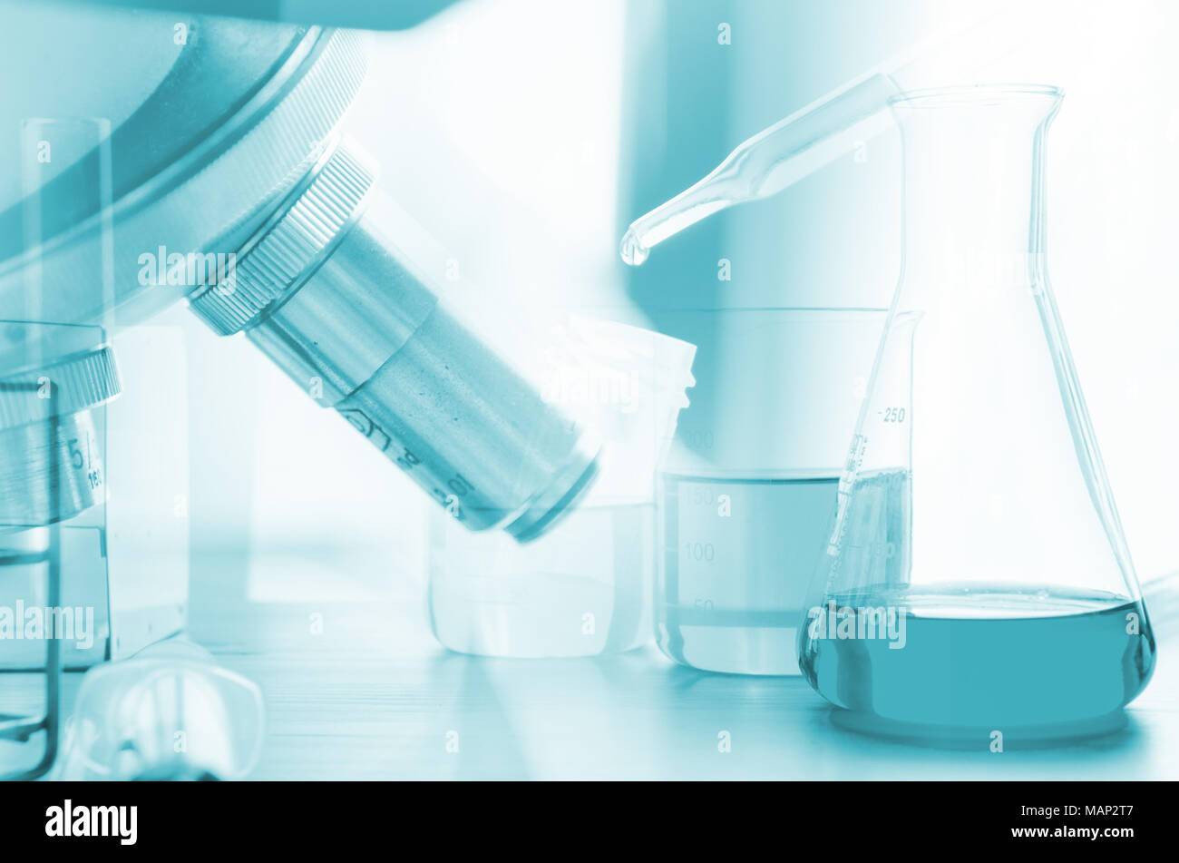 three erlenmeyer flask and microscope , Glassware on  science laboratory research and development Stock Photo